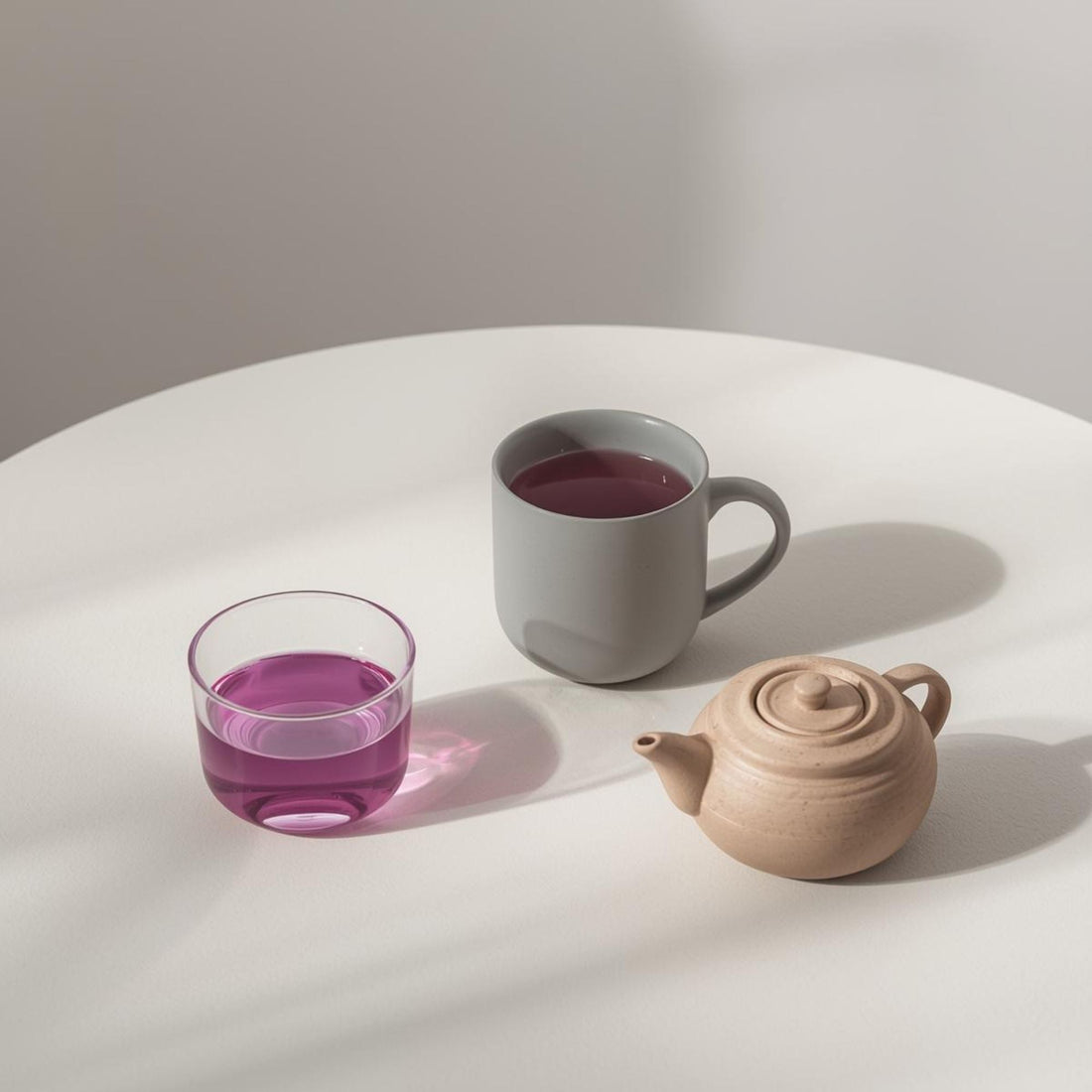 purple tea served in ceramic teacup on white surface