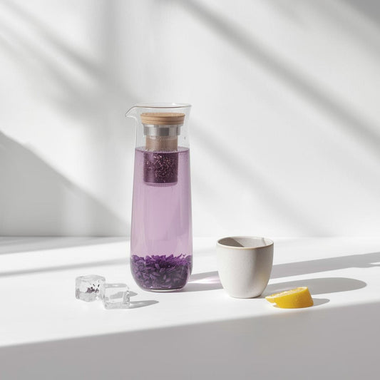 freshly brewed purple tea in clear glass teacup on white background