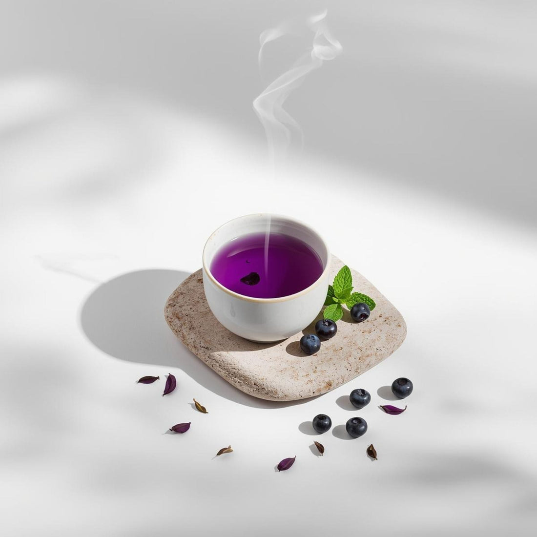 purple tea infusion in minimalist teacup on white background