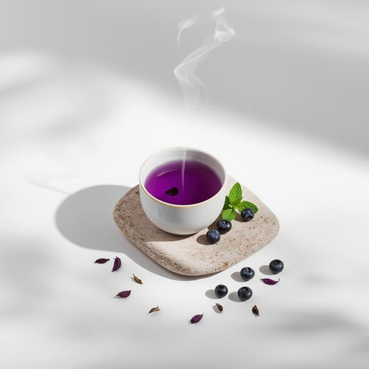 purple tea infusion in minimalist teacup on white background