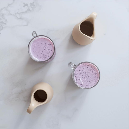 purple tea latte with oat milk in glass cup