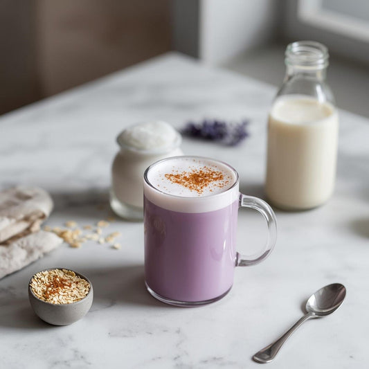 purple tea latte in glass cup with plant based milk