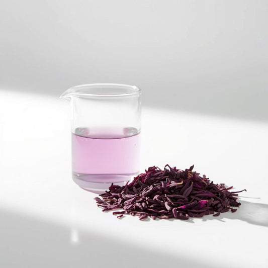 Macro close-up of purple tea leaves showing violet tones on a white background