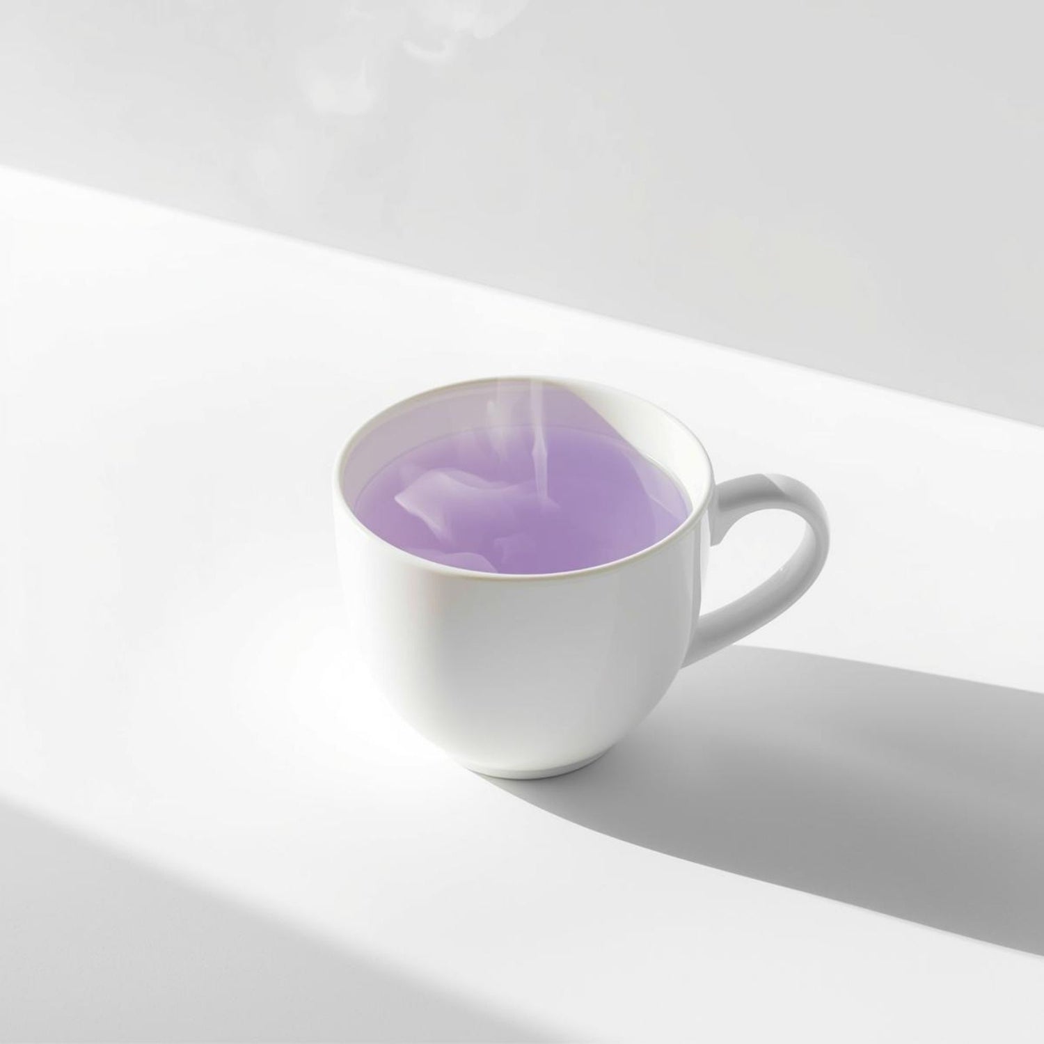 Minimal white ceramic cup filled with purple tea on a clean white background